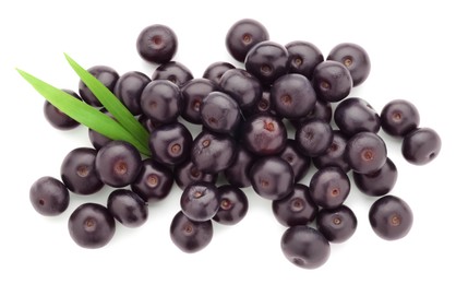 Photo of Fresh ripe acai berries and green leaves isolated on white, top view