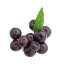 Photo of Fresh ripe acai berries and green leaves isolated on white, top view