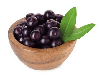 Photo of Fresh ripe acai berries in bowl and green leaves isolated on white