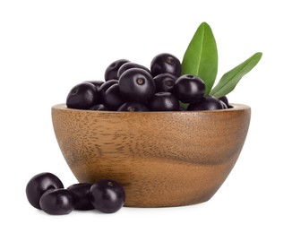 Photo of Fresh ripe acai berries in bowl and green leaves isolated on white