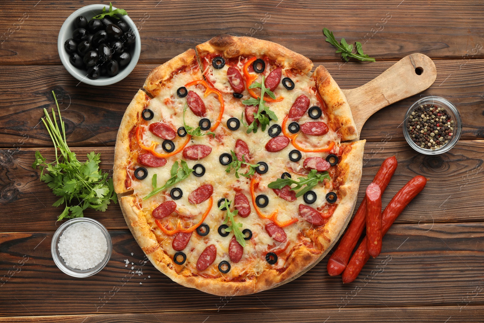 Photo of Tasty pizza and ingredients on wooden table, top view