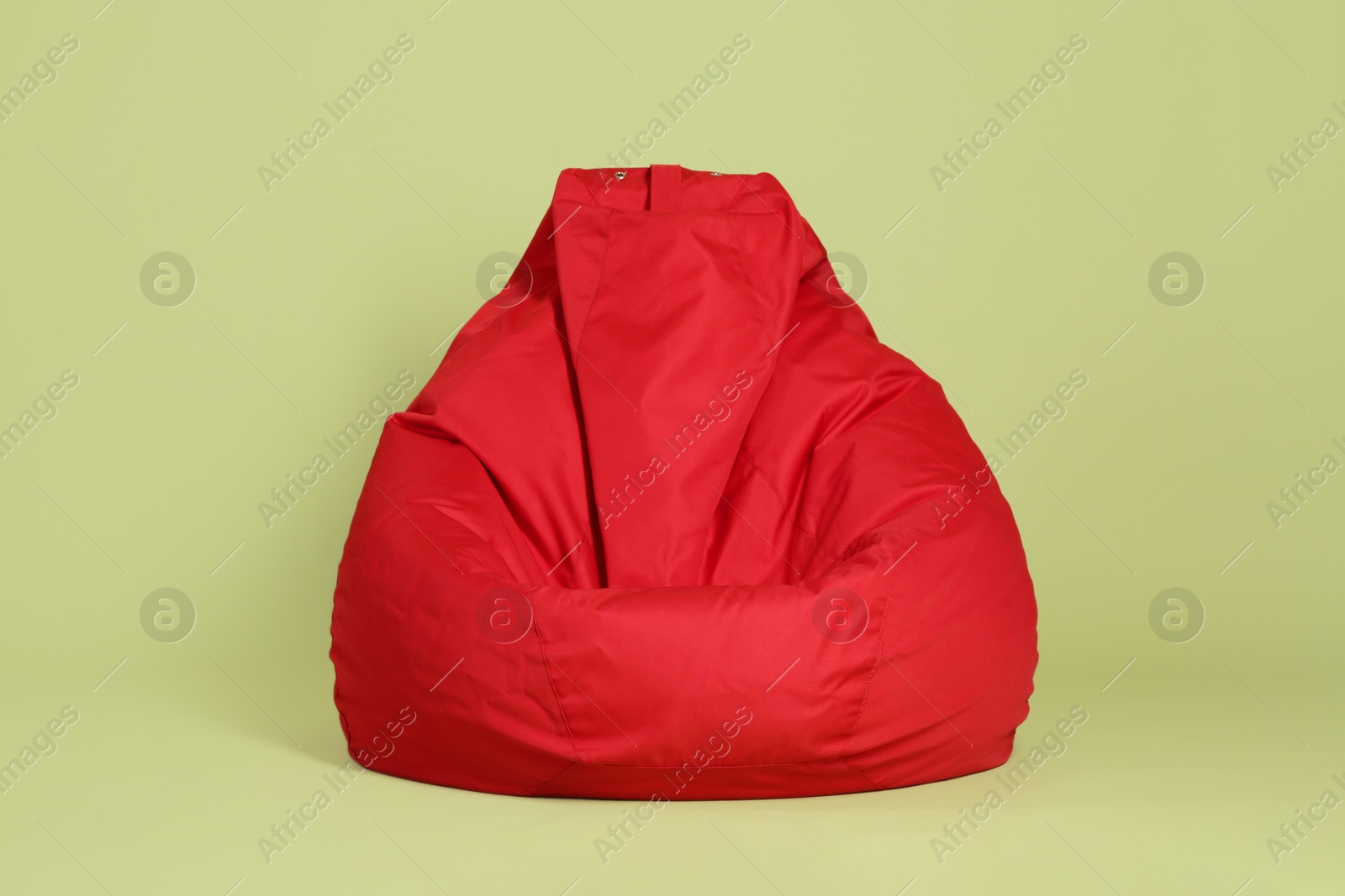 Photo of Red bean bag chair on olive background