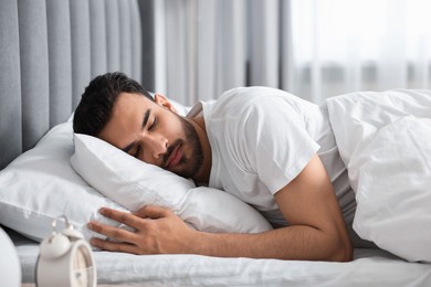 Photo of Handsome man sleeping in bed at morning