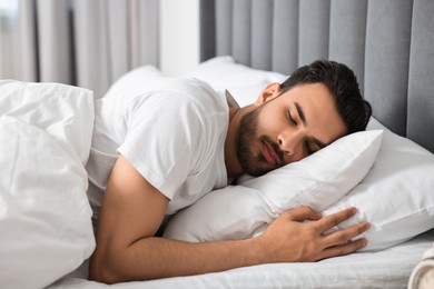 Photo of Handsome man sleeping in bed at morning