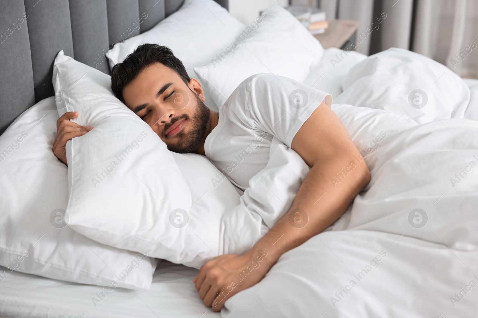 Photo of Handsome man sleeping in bed at morning