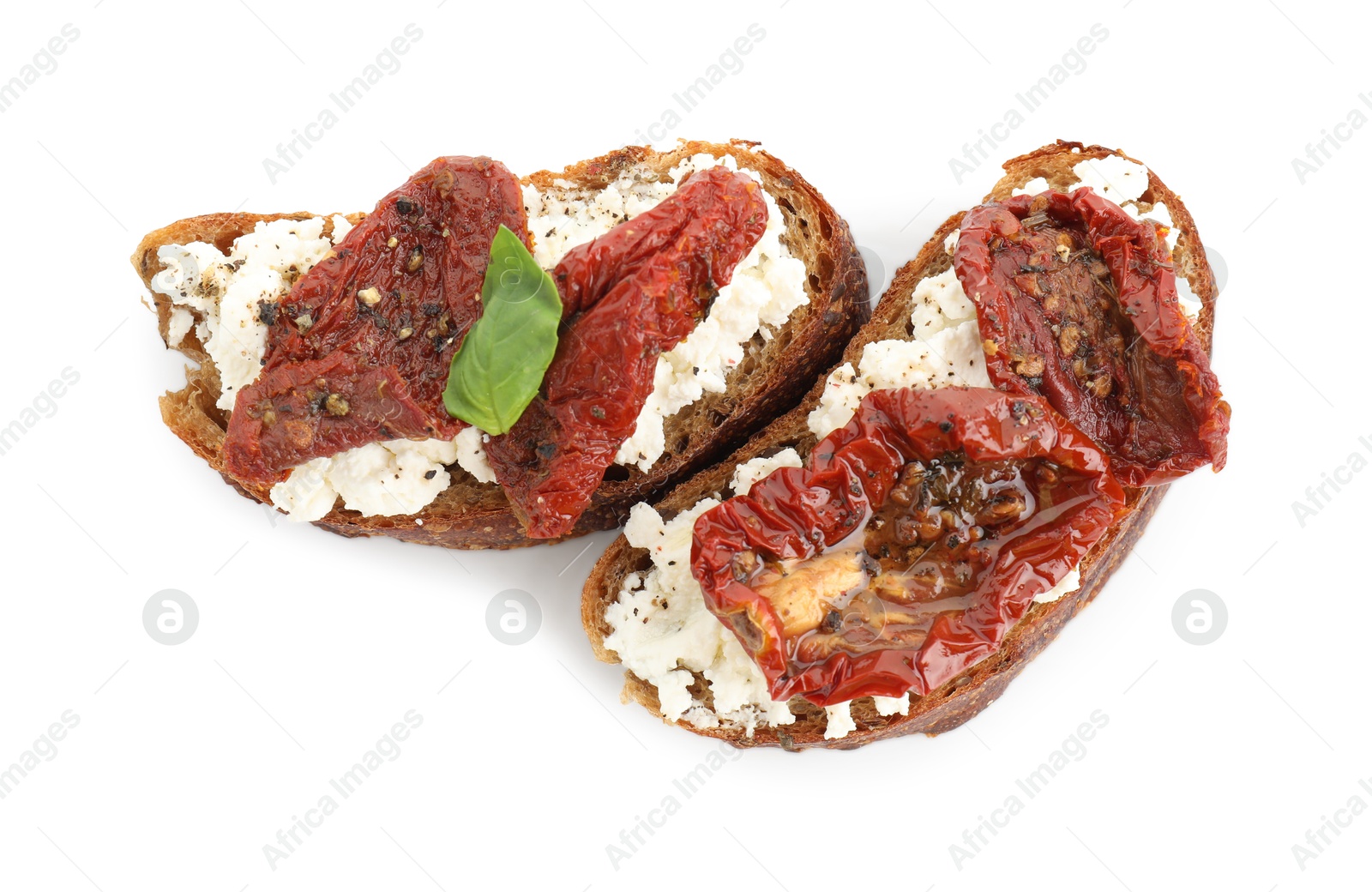 Photo of Delicious ricotta bruschettas with sun dried tomatoes and basil isolated on white, top view