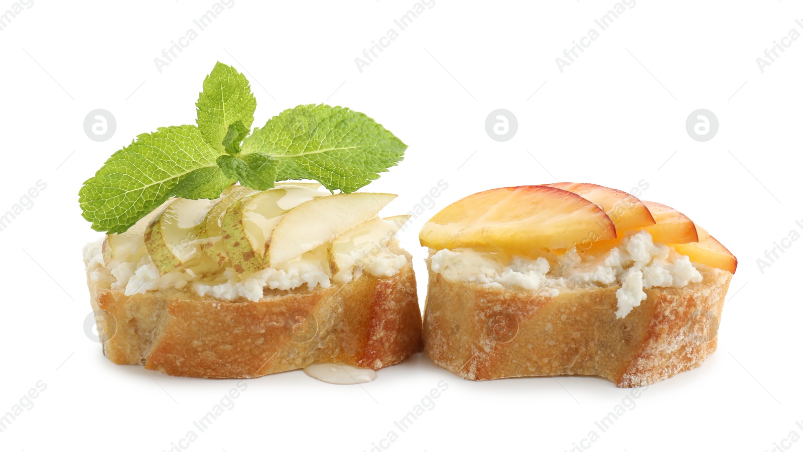 Photo of Delicious ricotta bruschettas with pears, apricots and mint isolated on white