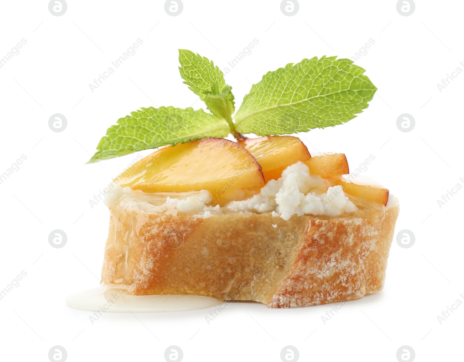 Photo of Delicious ricotta bruschetta with apricot and mint isolated on white