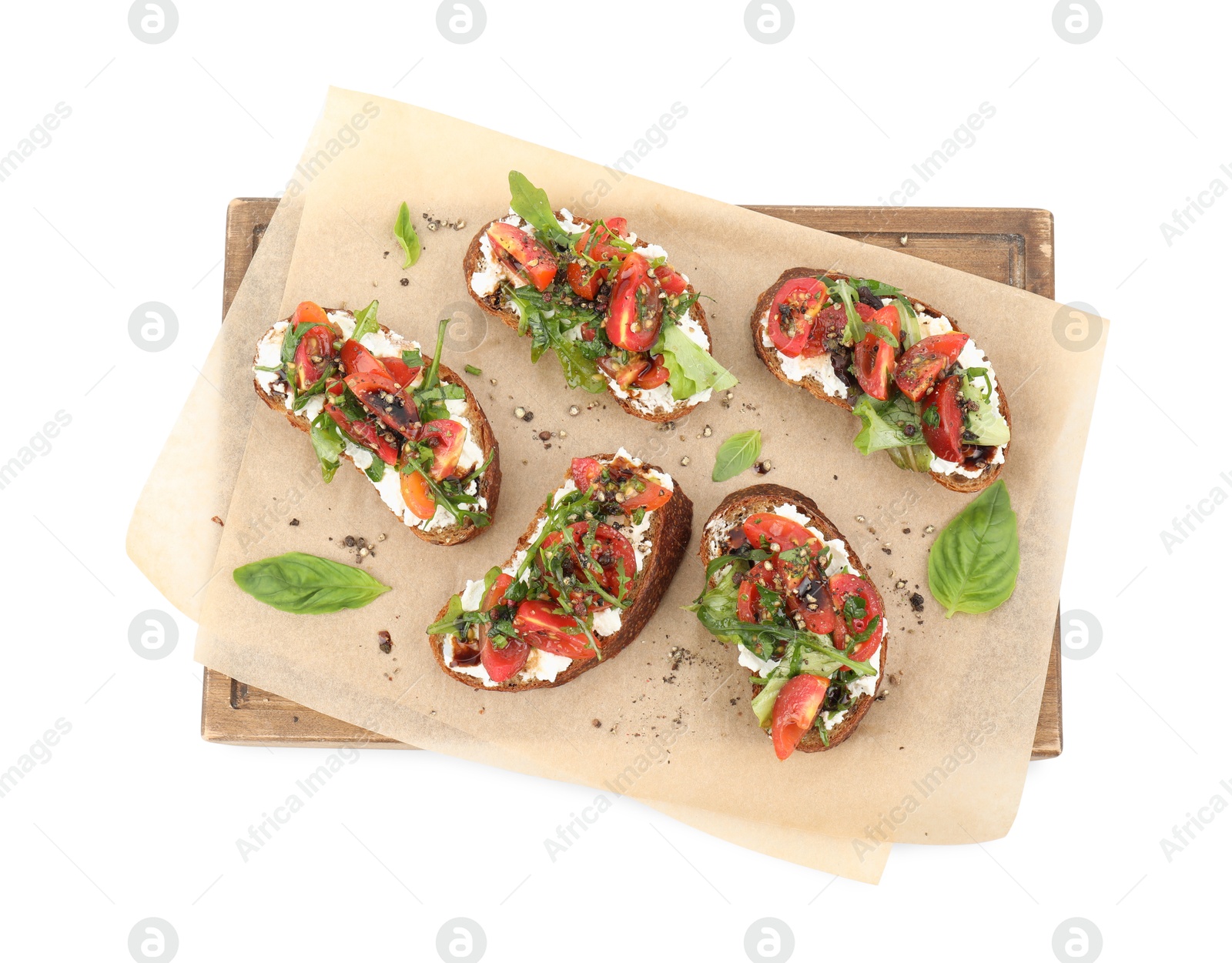 Photo of Delicious ricotta bruschettas with tomatoes, arugula and basil isolated on white, top view