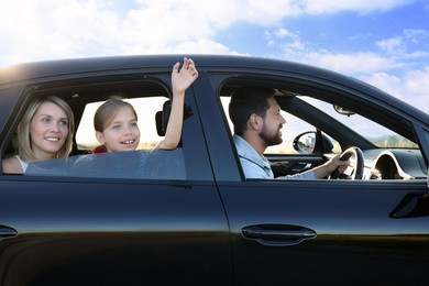 Happy family enjoying trip together by car, view from outside