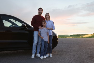 Photo of Happy parents and their daughter near car outdoors, space for text