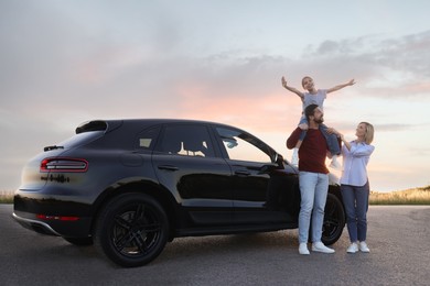 Happy parents and their daughter near car outdoors