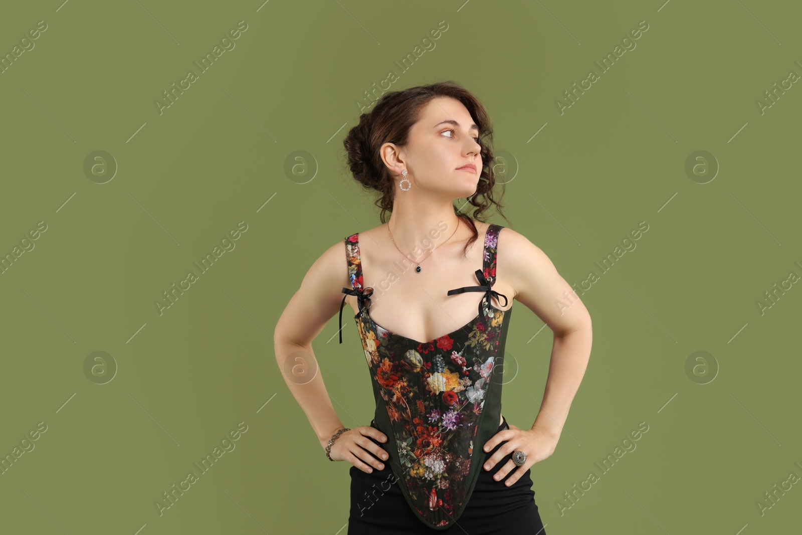 Photo of Beautiful woman in stylish corset on green background. Space for text