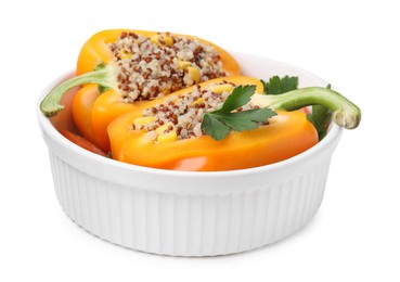 Photo of Quinoa stuffed bell pepper and parsley in bowl isolated on white