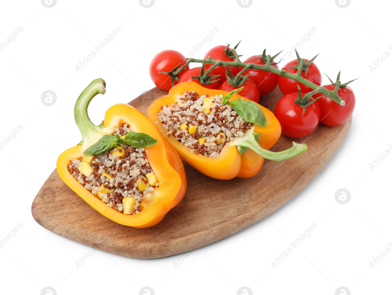 Photo of Board with quinoa stuffed bell pepper, parsley and tomatoes isolated on white