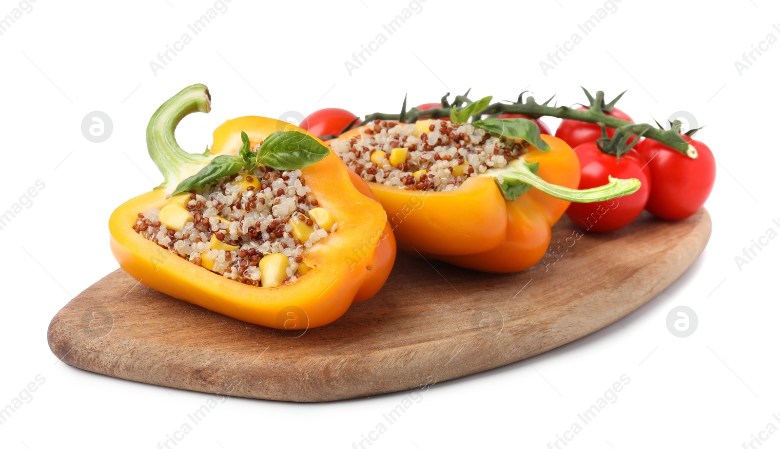 Photo of Board with quinoa stuffed bell pepper, parsley and tomatoes isolated on white