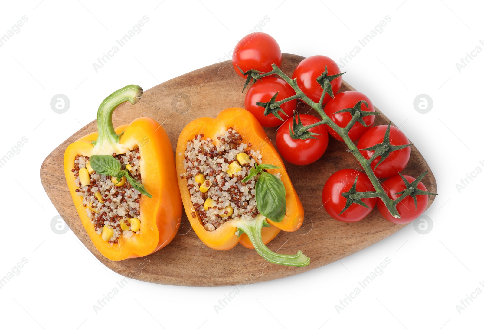 Photo of Board with quinoa stuffed bell pepper, parsley and tomatoes isolated on white, top view