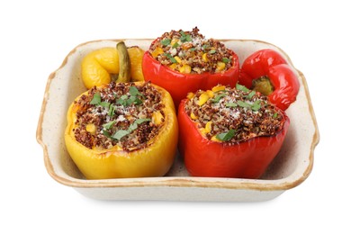 Photo of Tasty quinoa stuffed bell peppers with corn in baking dish isolated on white