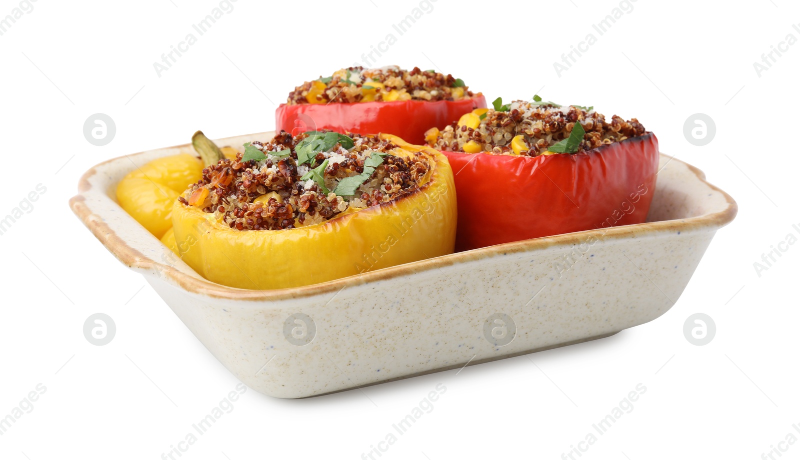 Photo of Tasty quinoa stuffed bell peppers with corn in baking dish isolated on white