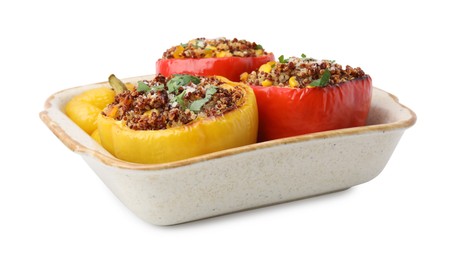 Photo of Tasty quinoa stuffed bell peppers with corn in baking dish isolated on white