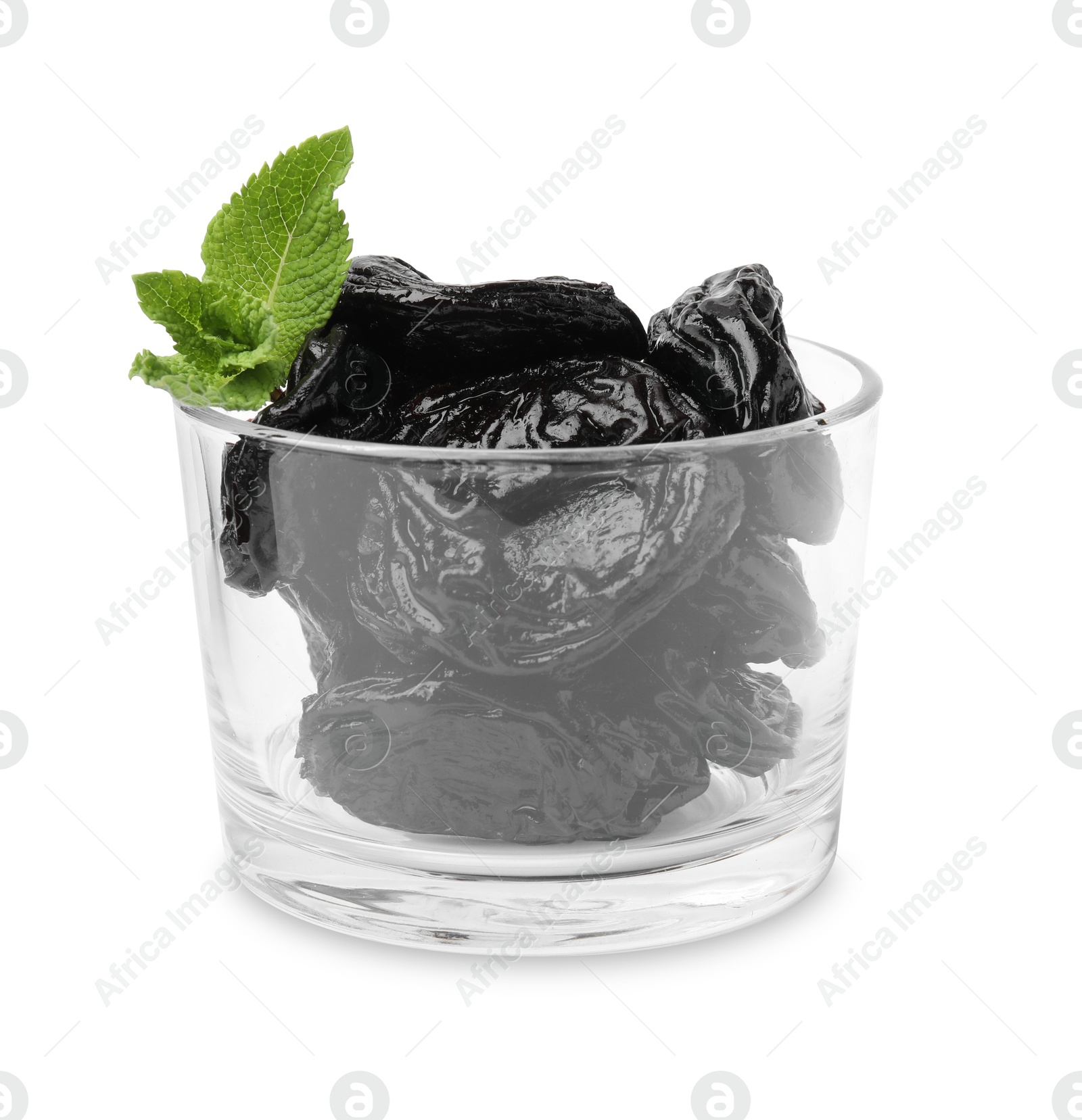 Photo of Tasty dried plums (prunes) in glass bowl and mint leaves isolated on white