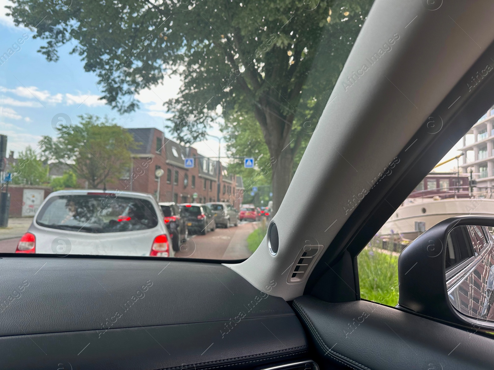 Photo of Cars in traffic jam on city street, view from driver's seat