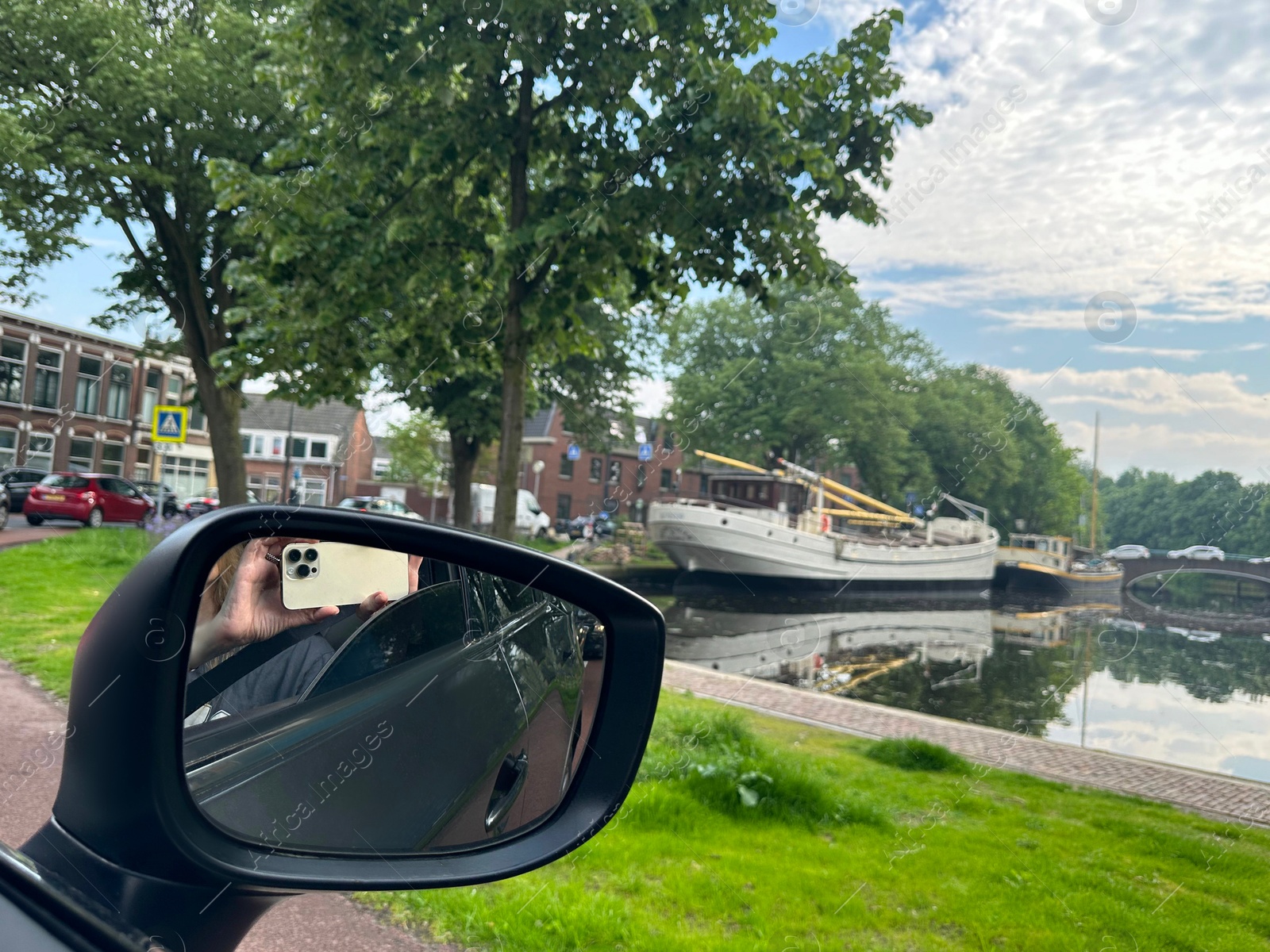 Photo of Canal with boats in city, view from driver's seat