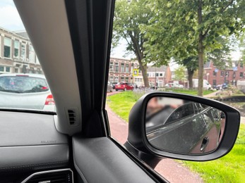 Cars in traffic jam on city street, view from driver's seat
