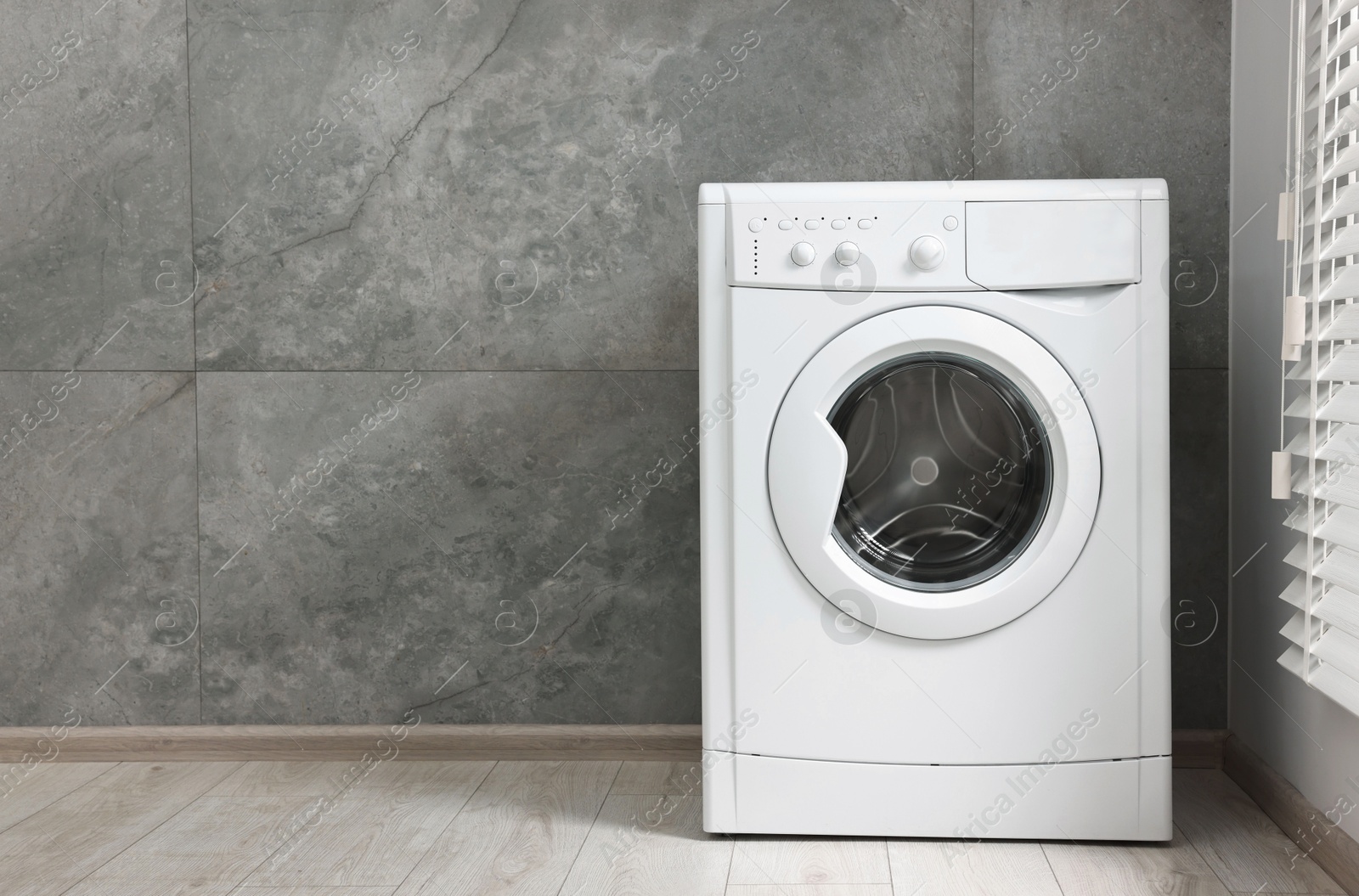 Photo of One washing machine in laundry room, space for text