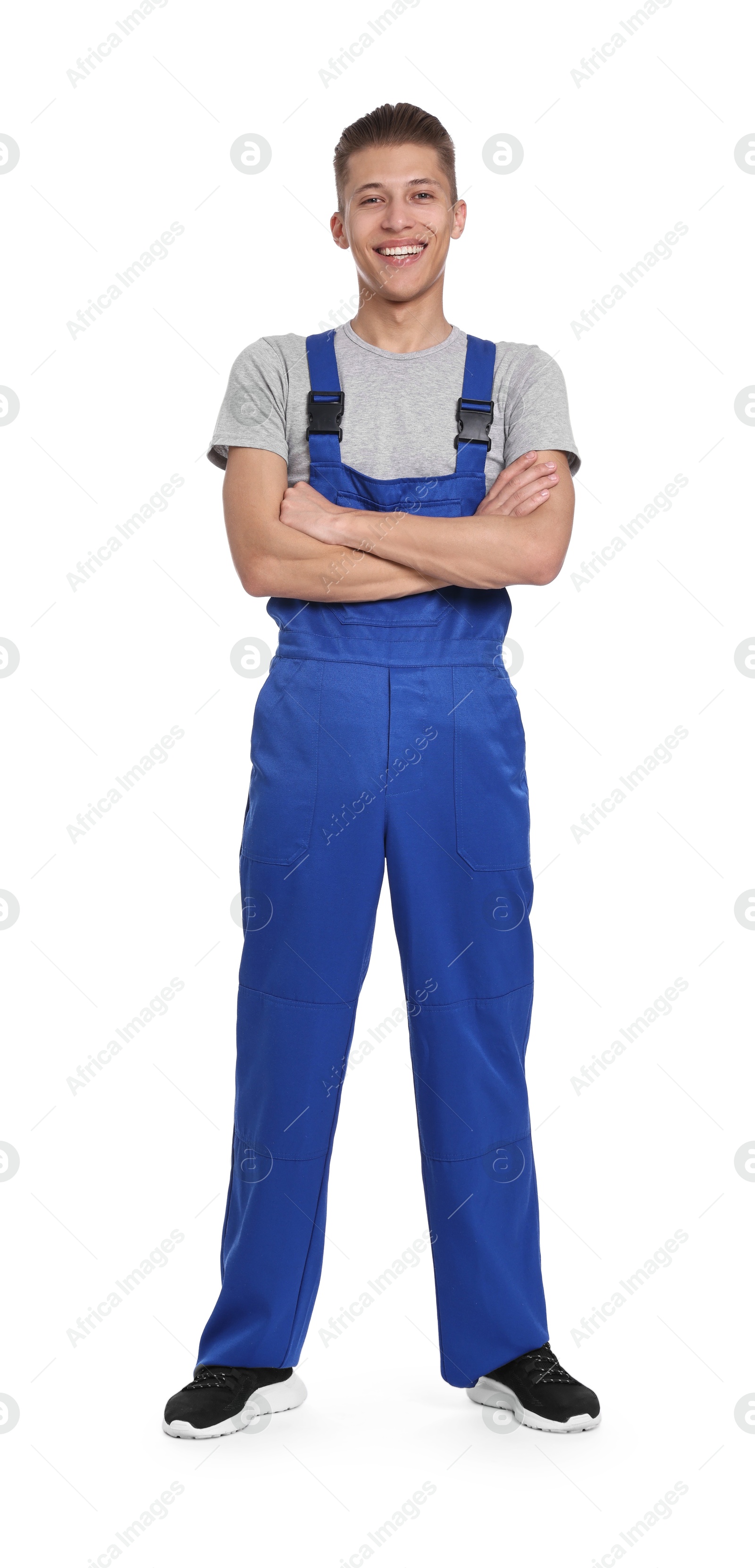 Photo of Smiling auto mechanic with crossed arms on white background