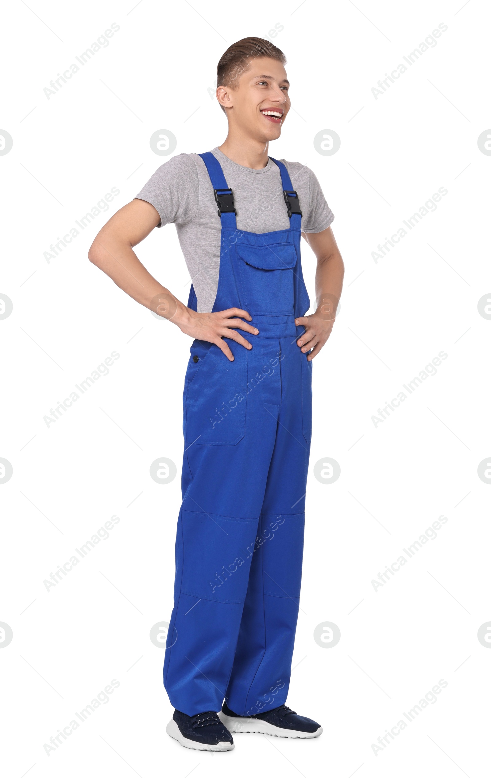 Photo of Smiling auto mechanic in uniform on white background