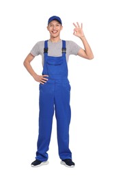 Smiling auto mechanic showing ok gesture on white background