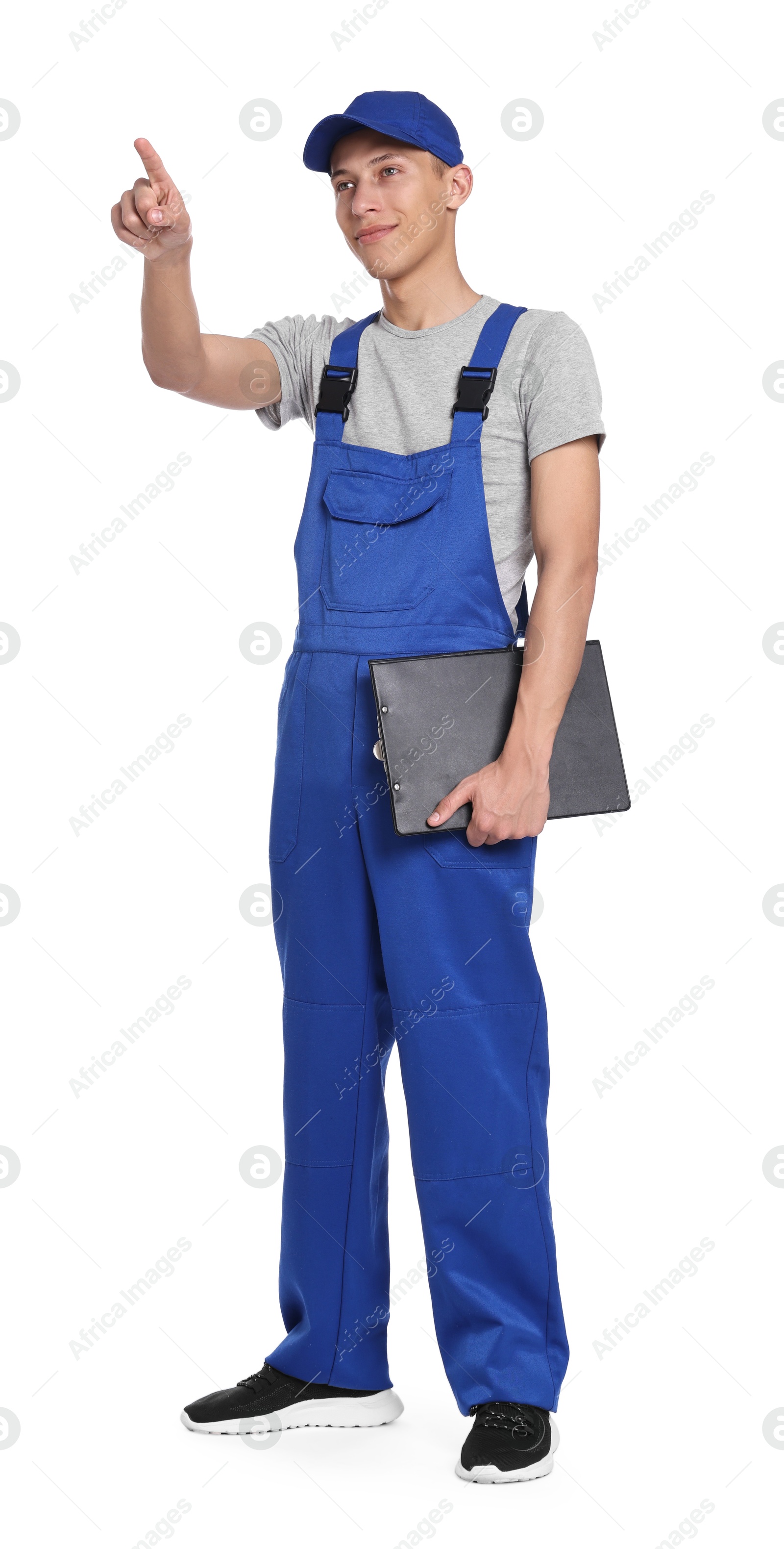 Photo of Auto mechanic with clipboard pointing at something on white background