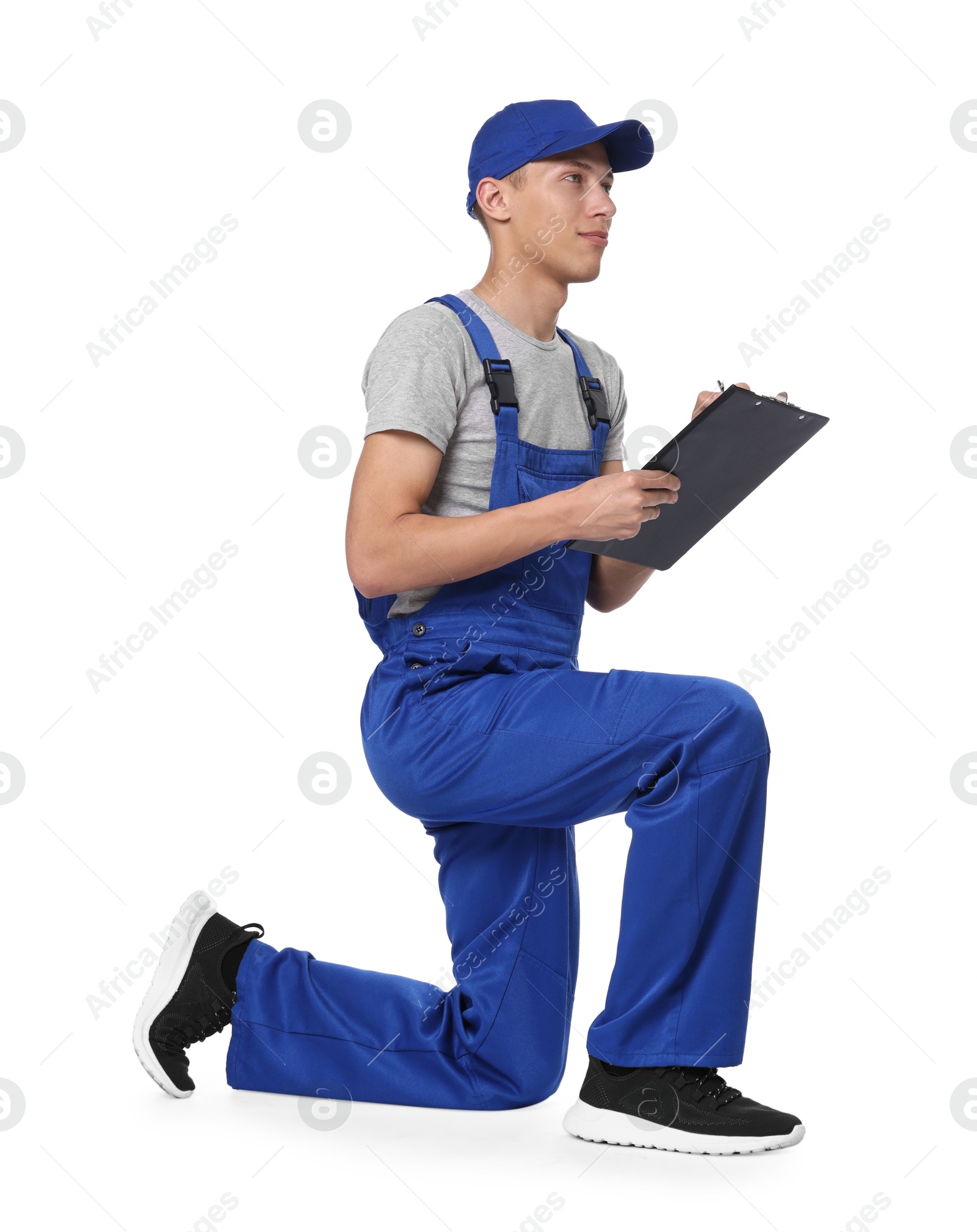 Photo of Auto mechanic working with clipboard on white background