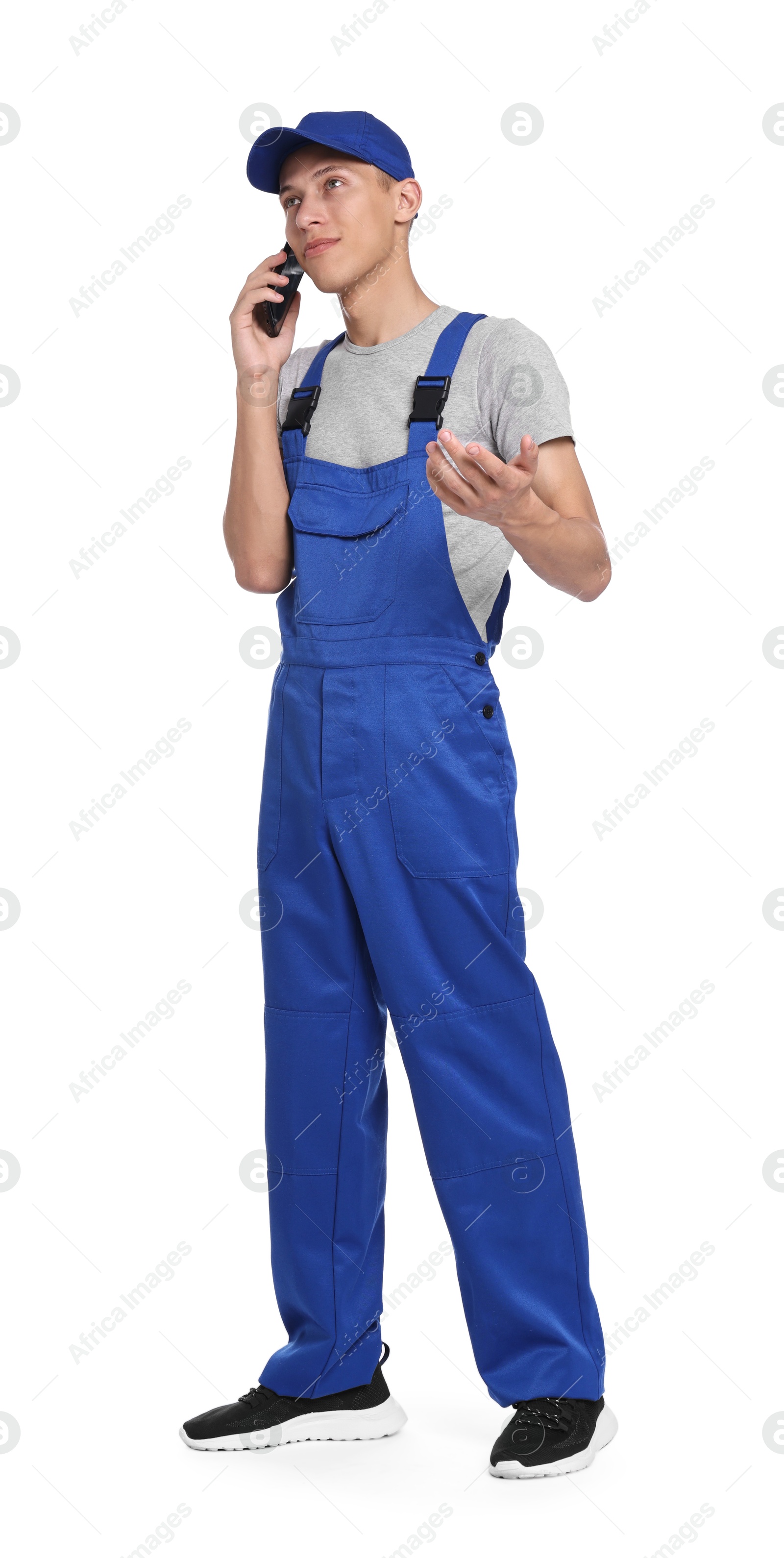 Photo of Auto mechanic talking by smartphone on white background