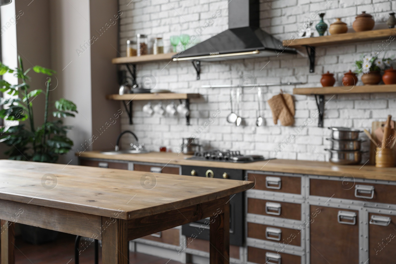 Photo of Empty wooden table in beautiful kitchen. Interior design