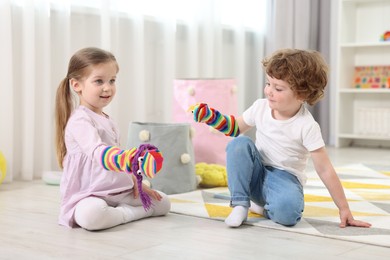 Photo of Cute little children playing with funny sock puppets in kindergarten