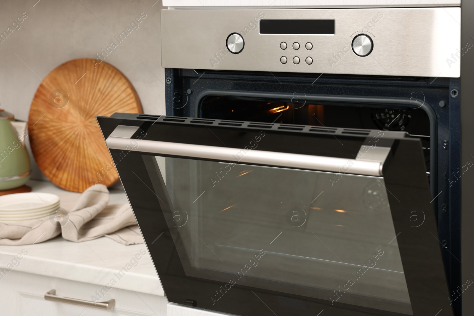 Photo of Open electric oven in kitchen. Cooking appliance