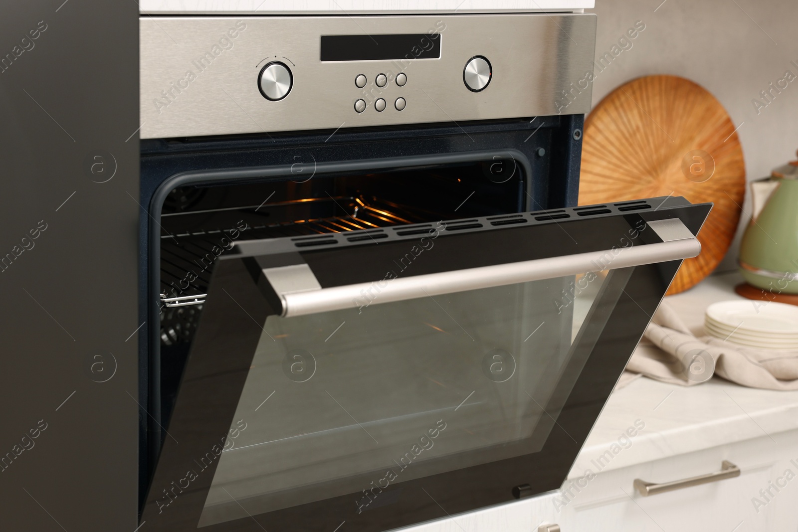 Photo of Open electric oven in kitchen. Cooking appliance