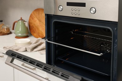 Photo of Open electric oven in kitchen. Cooking appliance