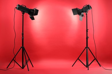 Photo of Red photo background and professional lighting equipment in studio