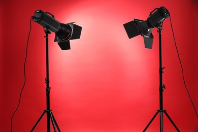 Red photo background and professional lighting equipment in studio