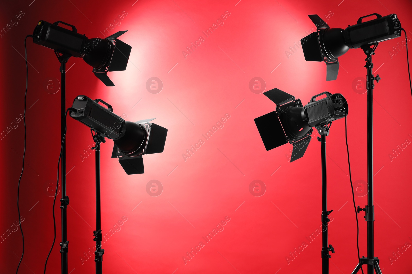 Photo of Red photo background and professional lighting equipment in studio