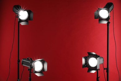 Red photo background and professional lighting equipment in studio