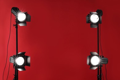 Photo of Red photo background and professional lighting equipment in studio