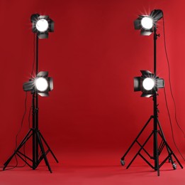 Photo of Red photo background and professional lighting equipment in studio