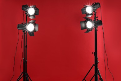 Red photo background and professional lighting equipment in studio