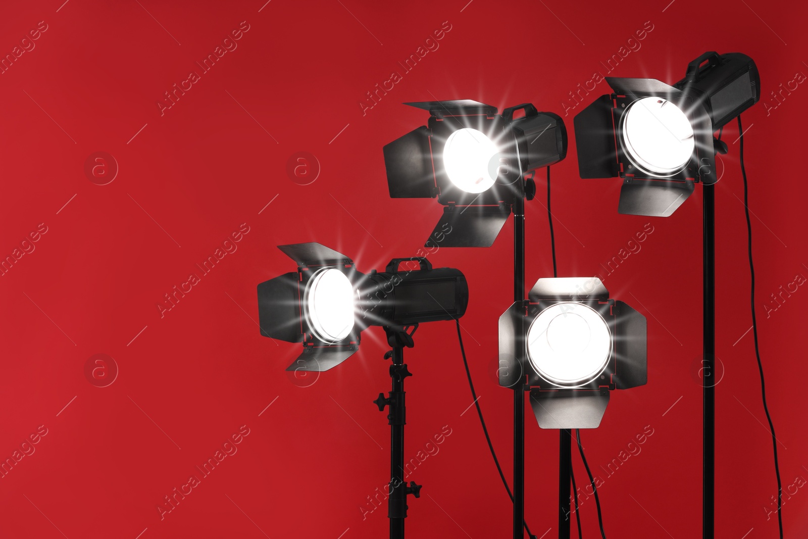 Photo of Red photo background and professional lighting equipment in studio, space for text