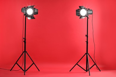 Photo of Red photo background and professional lighting equipment in studio