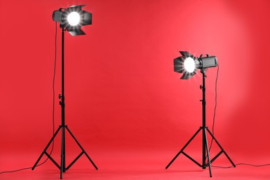 Photo of Red photo background and professional lighting equipment in studio